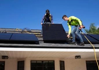 Installing solar panels on roof for sustainable alternatives.